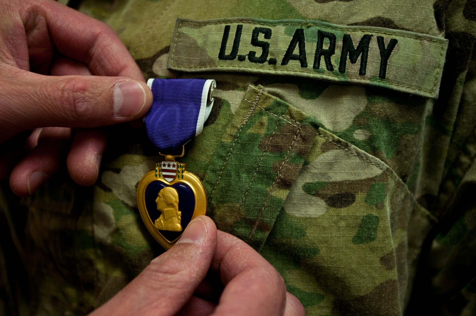 A Purple Heart is presented on a U.S. Army uniform