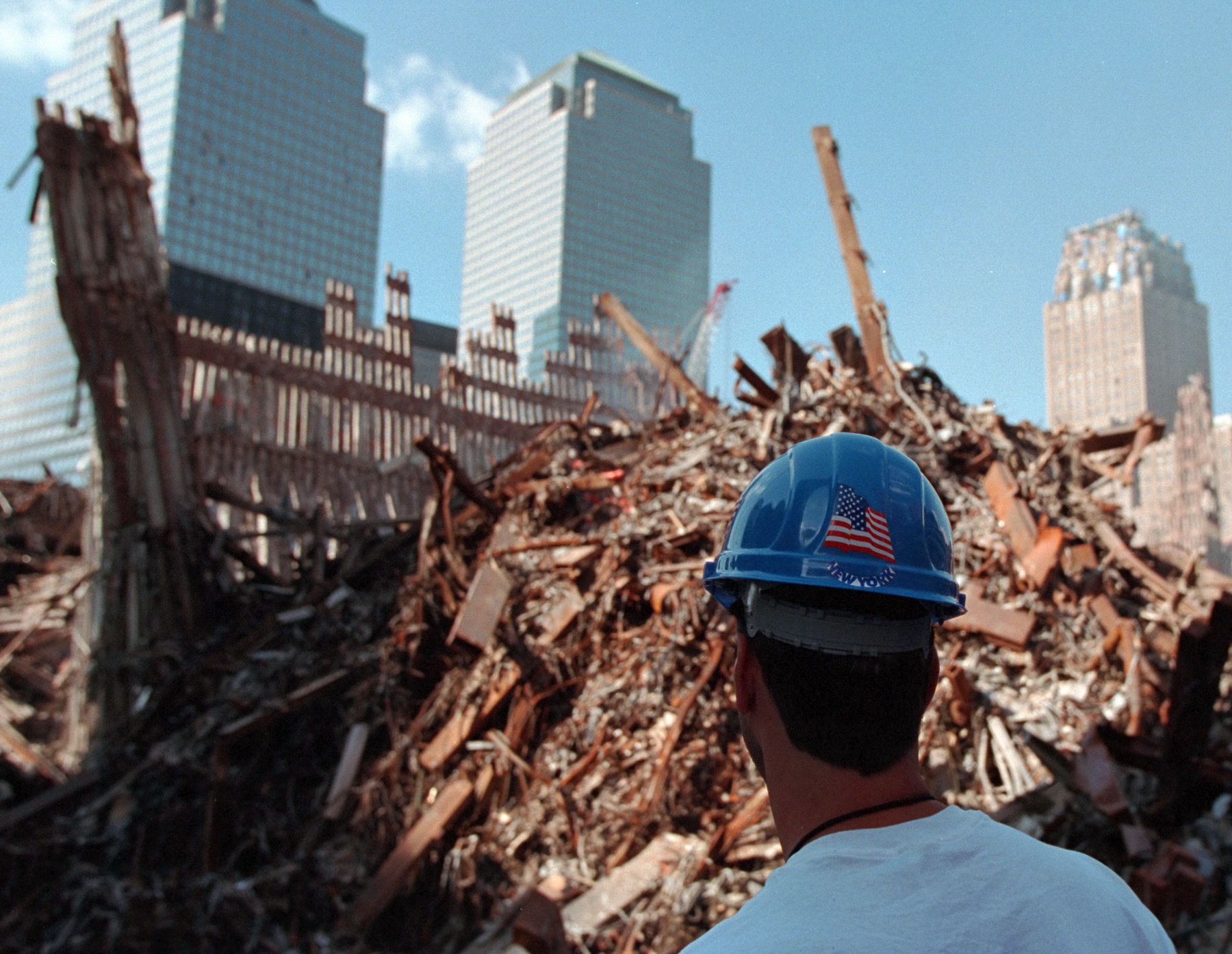 A recovery worker looks out over Ground Zero in New York City after September 11, 2001