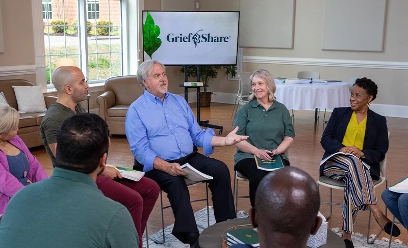 A GriefShare support group seated in a circle, talking together